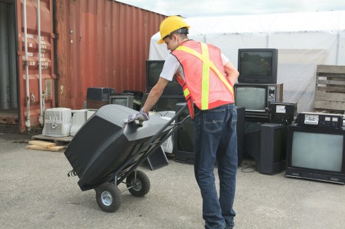 Operatives clearing a garage full of mixed waste in a suburban Victorian street